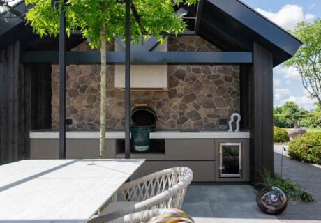 Outdoor kitchen with full cocktail bar in a modern garden room